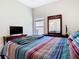 Cozy bedroom with a queen-sized bed, ceiling fan and natural light at 10875 Arbor View Blvd, Orlando, FL 32825