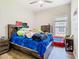 Bedroom with ceiling fan, a large bed, and a window that provides natural light at 10875 Arbor View Blvd, Orlando, FL 32825