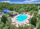 Aerial view of large community pool with many chairs and lush landscaping at 10875 Arbor View Blvd, Orlando, FL 32825