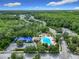 Aerial view showcasing a large community pool surrounded by lounge chairs, palm trees, and a backdrop of lush greenery at 10875 Arbor View Blvd, Orlando, FL 32825