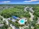A stunning aerial shot of a community pool area, surrounded by lush greenery and neighborhood homes at 10875 Arbor View Blvd, Orlando, FL 32825