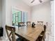 The dining room features a wooden table and chairs and overlooks the screened-in patio at 10875 Arbor View Blvd, Orlando, FL 32825