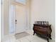Inviting entryway with a white door, sidelights, and decorative chest of drawers at 10875 Arbor View Blvd, Orlando, FL 32825