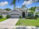 Charming home with a well-manicured lawn, a two-car garage and neatly trimmed hedges at 10875 Arbor View Blvd, Orlando, FL 32825