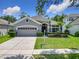 Charming home with a well-manicured lawn, a two-car garage and neatly trimmed hedges at 10875 Arbor View Blvd, Orlando, FL 32825