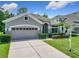 Charming home with a well-manicured lawn, a two-car garage and neatly trimmed hedges at 10875 Arbor View Blvd, Orlando, FL 32825