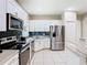 Modern kitchen equipped with stainless steel appliances, white cabinets, and granite countertops at 10875 Arbor View Blvd, Orlando, FL 32825