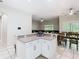 Bright kitchen with granite countertops and breakfast bar opens to the dining and living area at 10875 Arbor View Blvd, Orlando, FL 32825