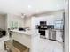 Modern kitchen with white cabinetry, stainless steel appliances, and a granite island perfect for entertaining at 10875 Arbor View Blvd, Orlando, FL 32825