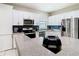 Contemporary kitchen with stainless appliances, granite counters and white cabinetry and tiled floors at 10875 Arbor View Blvd, Orlando, FL 32825