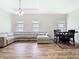 Inviting living room with a sectional sofa, wood floors, dining table, and natural lighting at 10875 Arbor View Blvd, Orlando, FL 32825