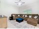 Spacious living room features a large sectional sofa and view of the backyard at 10875 Arbor View Blvd, Orlando, FL 32825