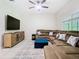 The living room showcases a comfortable sectional sofa and stylish furnishings at 10875 Arbor View Blvd, Orlando, FL 32825