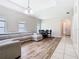 Spacious living room featuring a large sectional sofa, wood floors, chandelier and dining table set at 10875 Arbor View Blvd, Orlando, FL 32825