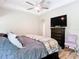 Bedroom featuring a ceiling fan, TV, wood-look floors and adjacent doorway at 10875 Arbor View Blvd, Orlando, FL 32825