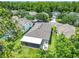 A beautiful home with a screened lanai and a well-manicured lawn is surrounded by lush trees, offering both privacy and scenic views at 10875 Arbor View Blvd, Orlando, FL 32825