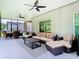 Large screened porch with dining and lounge areas, complete with ceiling fans at 10875 Arbor View Blvd, Orlando, FL 32825