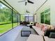 Expansive screened porch with multiple seating options and views of the outdoors at 10875 Arbor View Blvd, Orlando, FL 32825