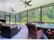 Spacious screened-in porch featuring wicker seating and ceiling fans, ideal for entertaining guests at 10875 Arbor View Blvd, Orlando, FL 32825