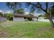 Large backyard featuring a partial view of the home’s rear exterior and some shade trees at 126 Ingram Cir, Longwood, FL 32779