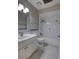 Bright bathroom featuring a single sink vanity, mirror, tiled bathtub, and shower at 126 Ingram Cir, Longwood, FL 32779