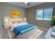 Stylishly decorated bedroom featuring a bed, colorful decor, and a bright window at 126 Ingram Cir, Longwood, FL 32779