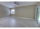 Light filled bedroom with a ceiling fan, tile floors and sliding glass doors to the outdoor space at 126 Ingram Cir, Longwood, FL 32779