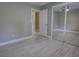 Bedroom featuring an open door with a mirrored closet and white tile floor at 126 Ingram Cir, Longwood, FL 32779