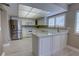 Bright kitchen featuring white cabinetry, modern appliances, and a breakfast bar at 126 Ingram Cir, Longwood, FL 32779