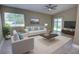 Bright living room features a ceiling fan, sliding glass doors, and modern furnishings for comfortable living at 126 Ingram Cir, Longwood, FL 32779