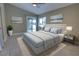 Comfortable primary bedroom with a large bed, neutral decor, and access to the outdoors through sliding glass doors at 126 Ingram Cir, Longwood, FL 32779