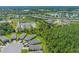 Aerial image of a residential area showcasing houses near green spaces and powerlines at 1392 Lombardi Ct, Kissimmee, FL 34759