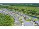 Scenic aerial view of a residential community with lush landscaping, waterways, and well-maintained homes at 1392 Lombardi Ct, Kissimmee, FL 34759