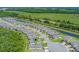 Scenic aerial view of a residential community with lush landscaping, waterways, and well-maintained homes at 1392 Lombardi Ct, Kissimmee, FL 34759
