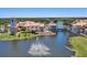 Beautiful aerial view of community buildings surrounding a water feature and landscaped grounds on a sunny day at 1392 Lombardi Ct, Kissimmee, FL 34759