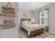 Cozy bedroom with a wood-framed bed, soft floral bedding, and a decorative 'Life is short' sign at 1392 Lombardi Ct, Kissimmee, FL 34759