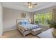 Cozy bedroom with a large window providing views of the lush, green landscape at 1392 Lombardi Ct, Kissimmee, FL 34759