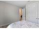 Comfortable bedroom with view to an open door showing a living room at 1392 Lombardi Ct, Kissimmee, FL 34759