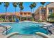 Large community pool with ample seating and lush landscaping creating an inviting space for leisure and socializing at 1392 Lombardi Ct, Kissimmee, FL 34759