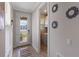 Bright entryway leading to laundry room, featuring decorative glass door and modern tile flooring at 1392 Lombardi Ct, Kissimmee, FL 34759