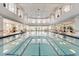 Large, well-lit indoor pool with ample seating, creating a luxurious and relaxing swimming environment at 1392 Lombardi Ct, Kissimmee, FL 34759