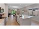Open-concept kitchen with a large island, stainless steel appliances, and a view into the living area at 1392 Lombardi Ct, Kissimmee, FL 34759