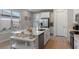 Bright kitchen featuring a large island, stainless steel appliances, and ample counter space at 1392 Lombardi Ct, Kissimmee, FL 34759