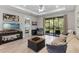 Inviting living room with comfortable seating, entertainment center, and access to bedroom and lanai at 1392 Lombardi Ct, Kissimmee, FL 34759