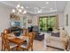 Bright living room featuring dining area, modern light fixture, and sliding doors to outdoor space at 1392 Lombardi Ct, Kissimmee, FL 34759