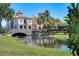 Beautifully landscaped waterfront property with a bridge leading to residences, creating a picturesque setting at 1392 Lombardi Ct, Kissimmee, FL 34759