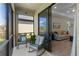 Relaxing screened porch with comfortable rocking chairs and a view to the home's living room at 1392 Lombardi Ct, Kissimmee, FL 34759
