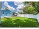 Spacious backyard featuring a well-maintained lawn, patio, and privacy fence at 141 W Main St, Lake Helen, FL 32744
