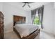 Bedroom with a large window offering natural light, and a wooden bed frame at 141 W Main St, Lake Helen, FL 32744