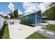 Beautiful home featuring a long driveway, white privacy fence, grill, and back patio at 141 W Main St, Lake Helen, FL 32744